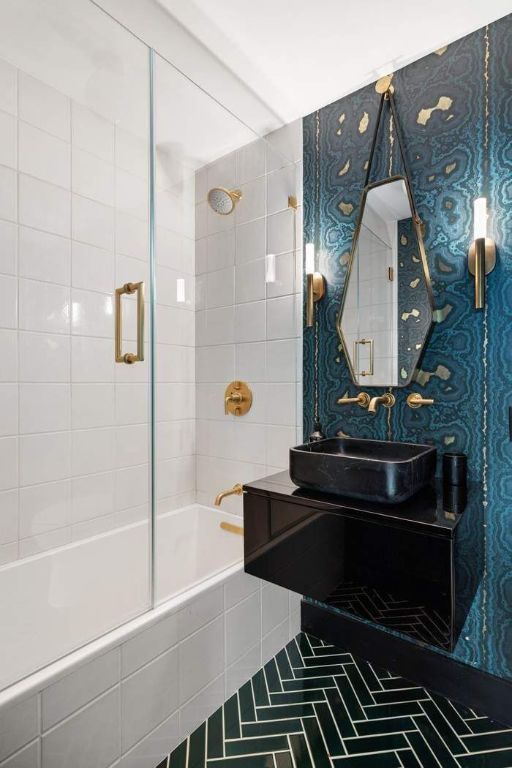 bathroom featuring tiled shower / bath, tile patterned floors, and vanity