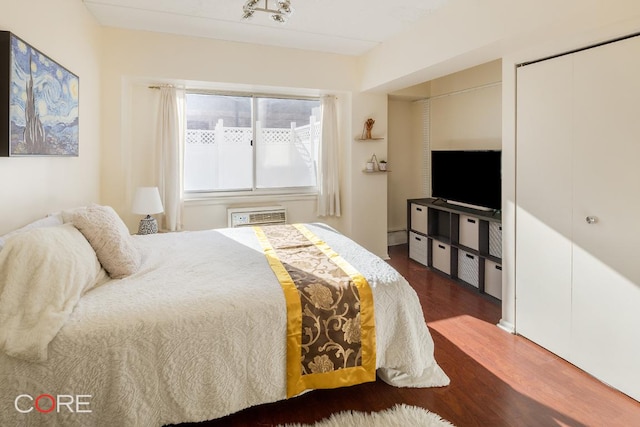 bedroom with dark wood-type flooring