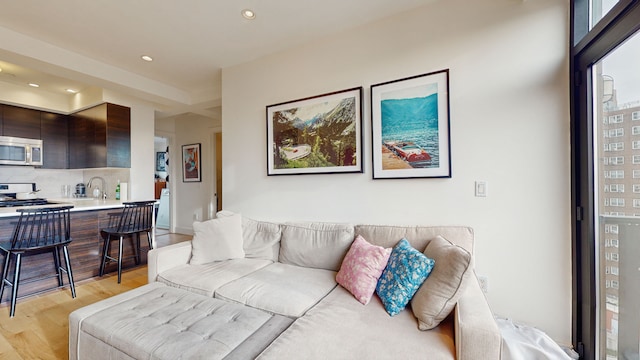 399 E 8th St Unit 8C, New York City, NY 10009 - living area featuring light wood-style floors, recessed lighting, and healthy amount of natural light