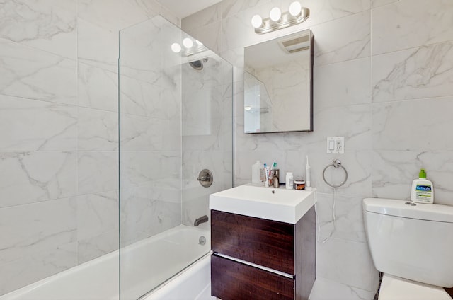 bathroom featuring tub / shower combination, tile walls, vanity, and toilet