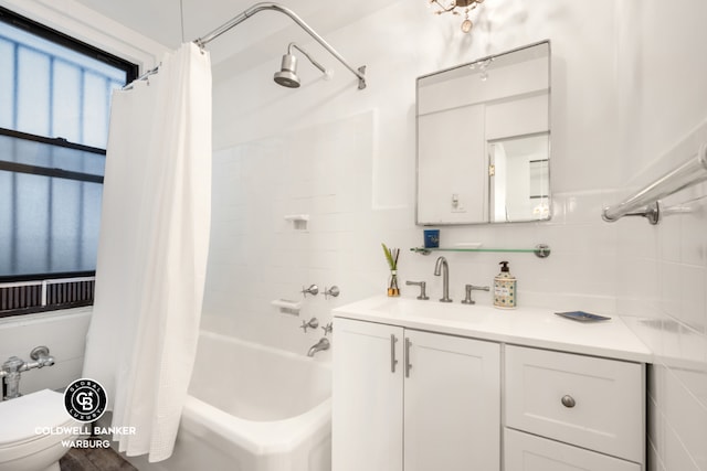 full bathroom with vanity, shower / bath combination with curtain, backsplash, toilet, and tile walls