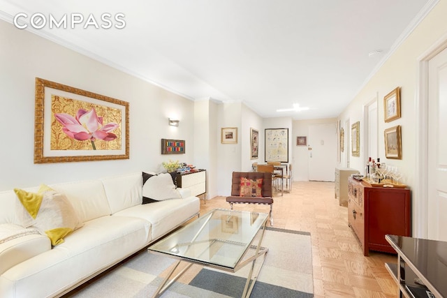 living room featuring crown molding and light parquet floors