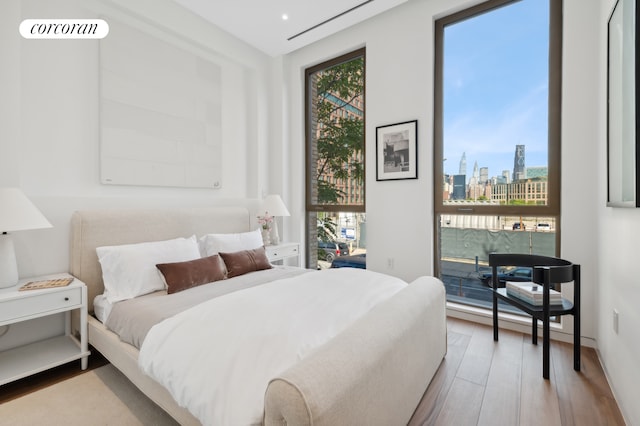 68 Commercial St Ph, Ph, New York City, NY 11222 - bedroom with wood finished floors and a view of skyline