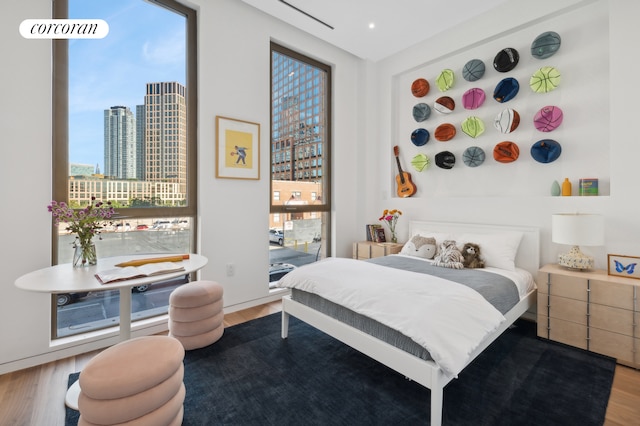 68 Commercial St Ph, Ph, New York City, NY 11222 - bedroom with wood finished floors and a skyline view