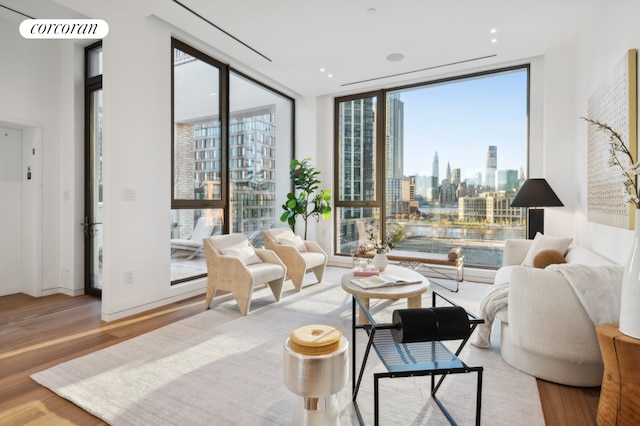 68 Commercial St Ph, Ph, New York City, NY 11222 - living room with a wall of windows, wood finished floors, and a skyline view