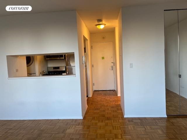 corridor featuring dark parquet flooring