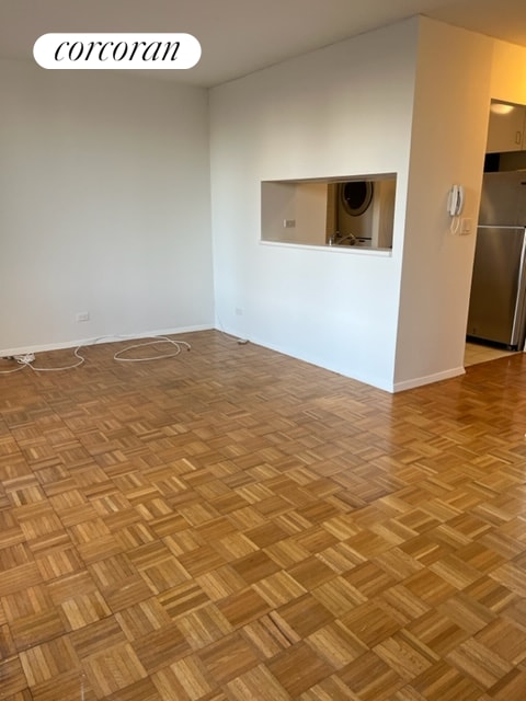 empty room with stacked washer and clothes dryer