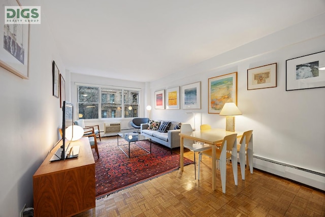 living room with a baseboard radiator and parquet floors