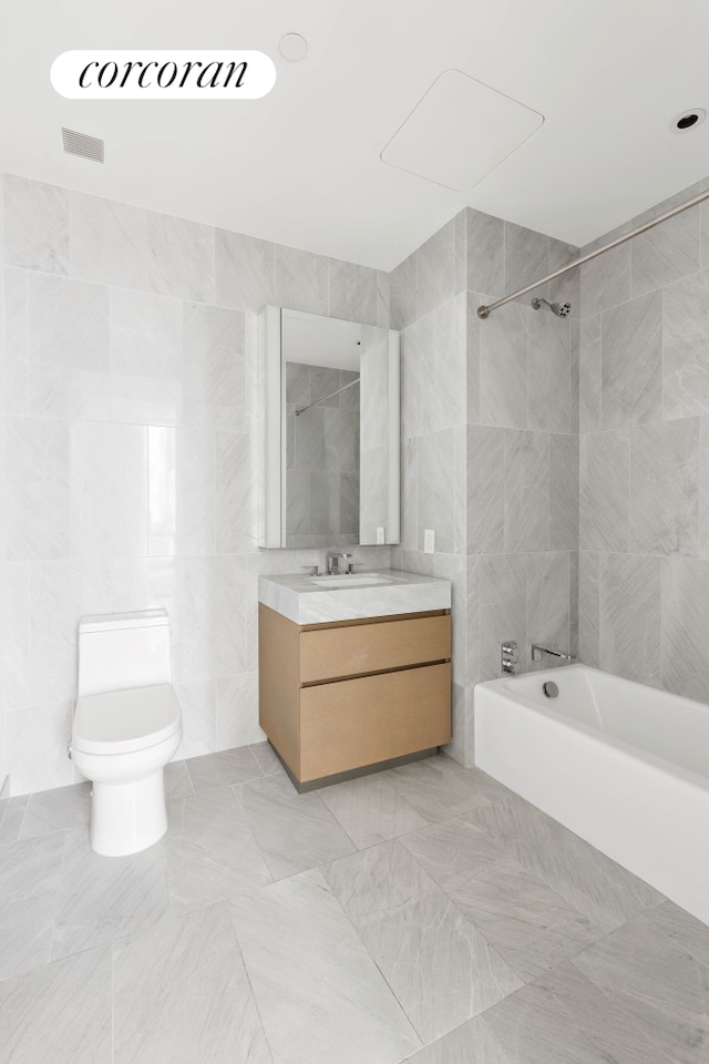 15 Hudson Yards Unit 67F, New York City, NY 10001 - full bath featuring tile walls, shower / bathtub combination, vanity, toilet, and tile patterned flooring