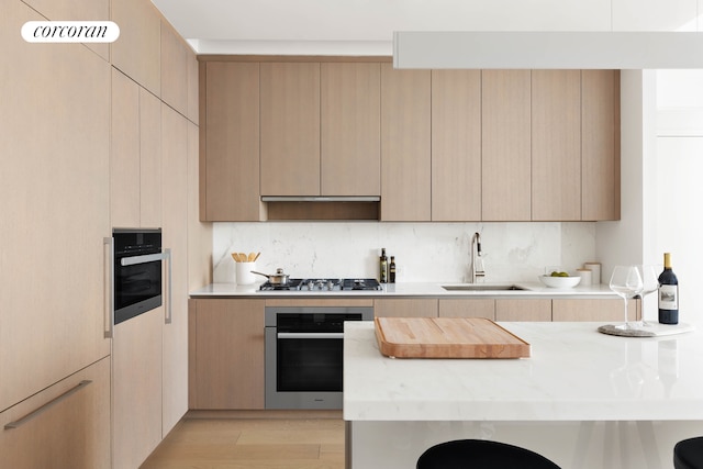15 Hudson Yards Unit 67F, New York City, NY 10001 - kitchen featuring appliances with stainless steel finishes, a sink, light wood finished floors, and modern cabinets