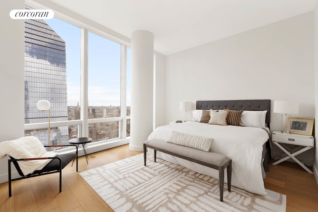 15 Hudson Yards Unit 67F, New York City, NY 10001 - bedroom with multiple windows and wood finished floors