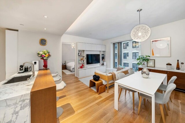 dining room with sink and light hardwood / wood-style flooring