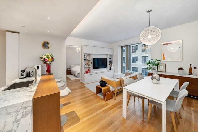 dining room featuring recessed lighting and light wood-style flooring