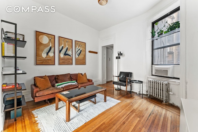 living room featuring light wood finished floors and radiator heating unit