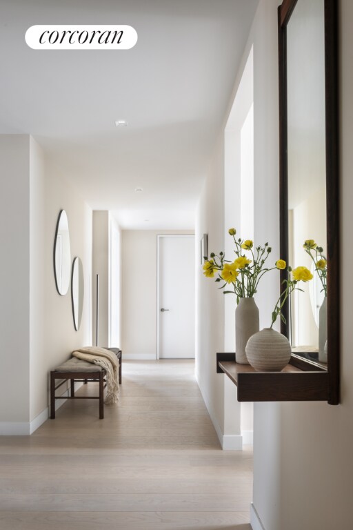 corridor with light hardwood / wood-style floors