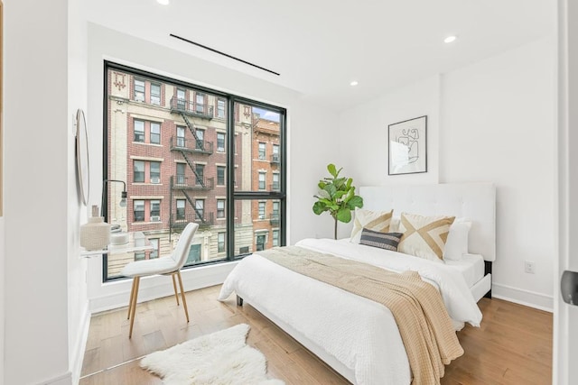 bedroom featuring light wood-style flooring, baseboards, and recessed lighting