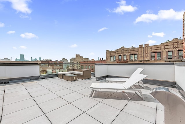 view of patio with an outdoor living space and a city view