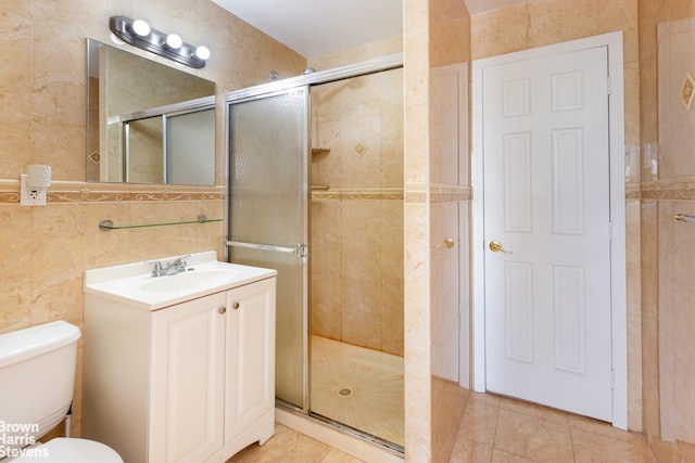 bathroom featuring tile walls, toilet, walk in shower, and vanity