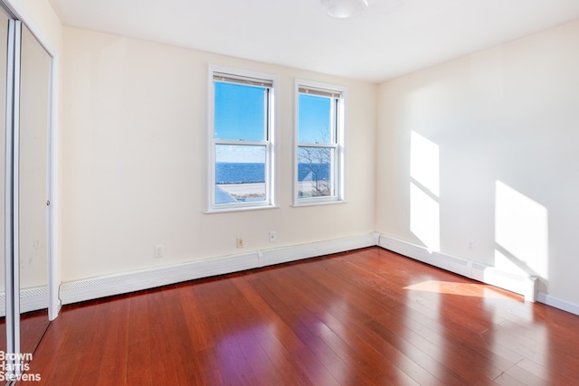 unfurnished room with wood-type flooring