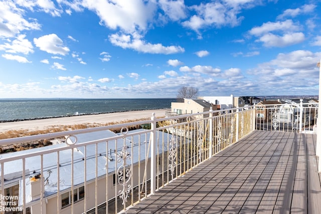 deck with a water view and a view of the beach