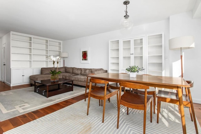 dining space with wood-type flooring