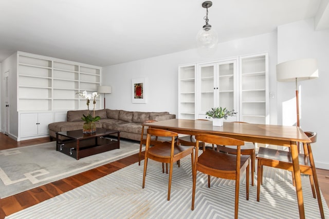 dining space with wood finished floors