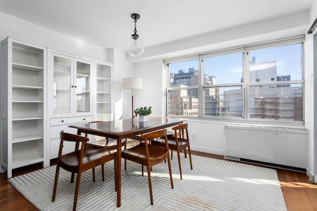 dining space featuring radiator and dark hardwood / wood-style flooring