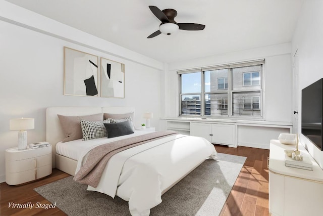 bedroom with ceiling fan and dark hardwood / wood-style flooring