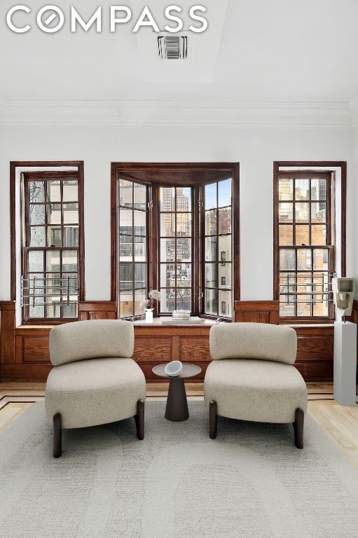 living area with ornamental molding