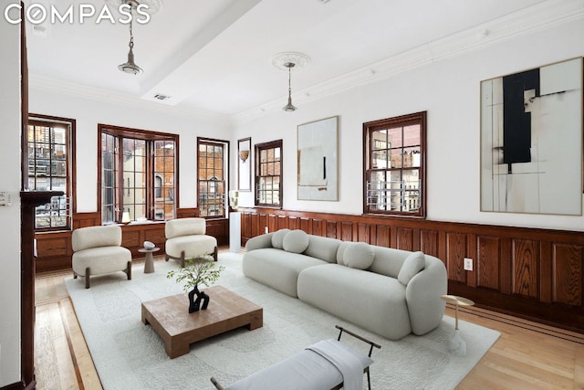 living room featuring light wood-type flooring, a wealth of natural light, and wood walls