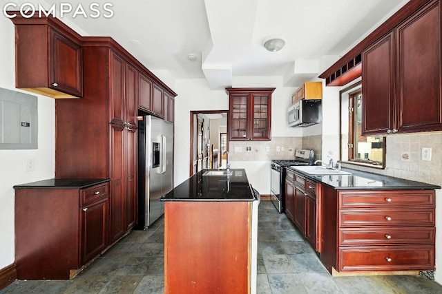 kitchen with a kitchen island, sink, stainless steel appliances, and electric panel