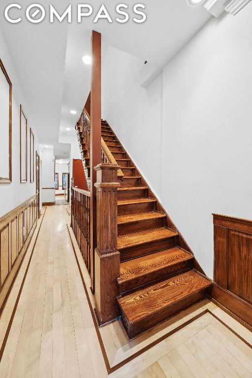 stairs featuring hardwood / wood-style flooring