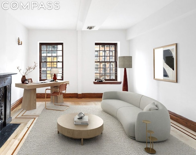 living room featuring hardwood / wood-style floors and a high end fireplace