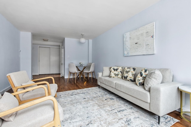 living room featuring wood finished floors and baseboards