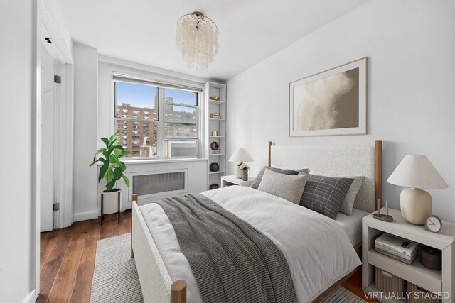 435 E 77th St Unit 10G, New York City, NY 10021 - bedroom featuring radiator and wood finished floors