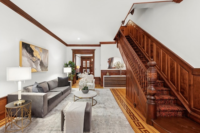 living area with stairway and ornamental molding