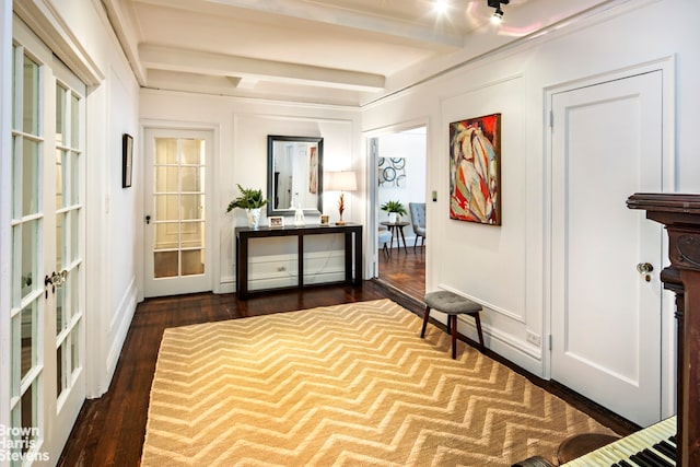 hallway featuring french doors, dark wood-type flooring, and beamed ceiling