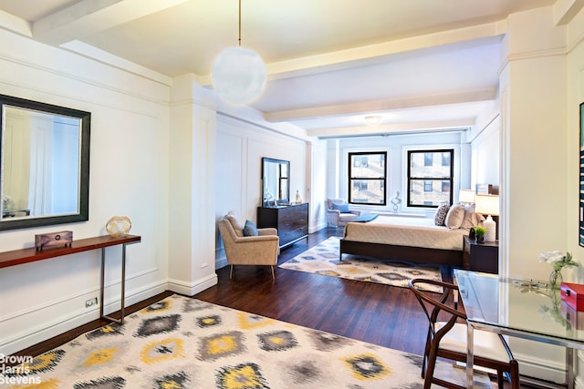 bedroom with dark hardwood / wood-style floors and beamed ceiling