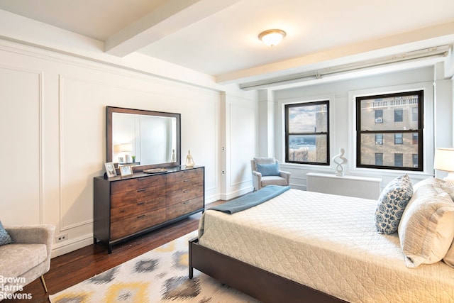 bedroom featuring dark hardwood / wood-style flooring and beam ceiling