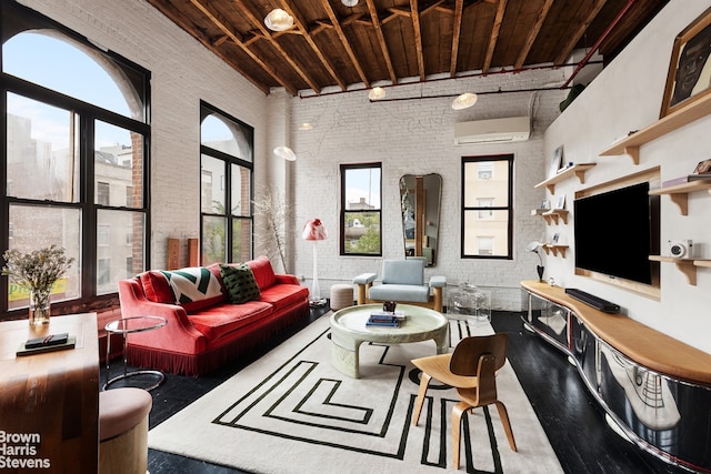 living room featuring wood ceiling, a wall unit AC, a towering ceiling, and brick wall