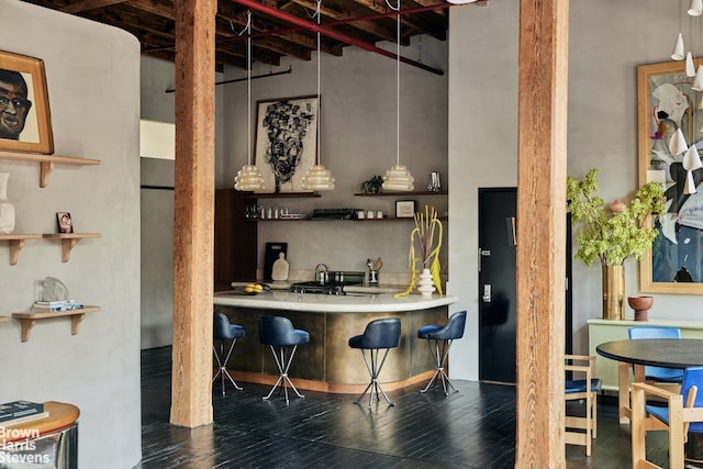 bar with wet bar and wood finished floors