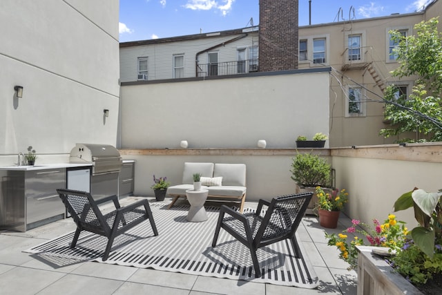 view of patio with area for grilling, sink, and outdoor lounge area