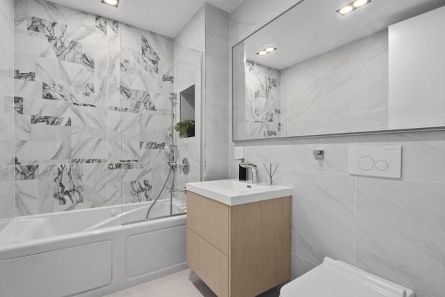 bathroom with  shower combination, tile walls, and vanity