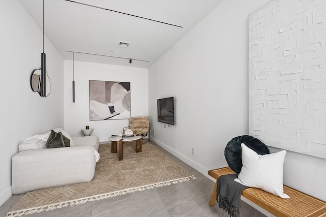 sitting room featuring visible vents and baseboards