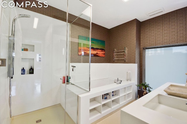 bathroom with walk in shower and sink