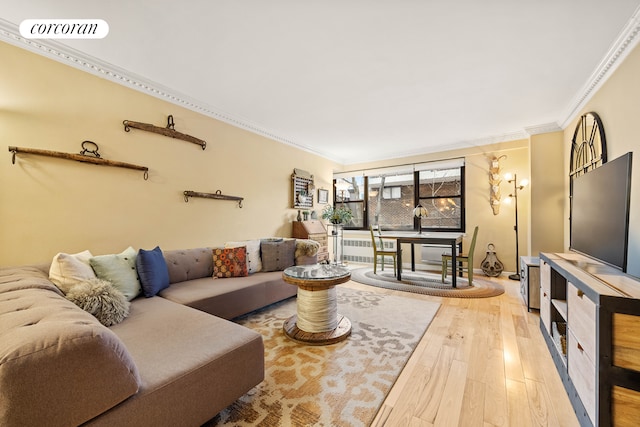 living area featuring visible vents, ornamental molding, radiator heating unit, and wood finished floors