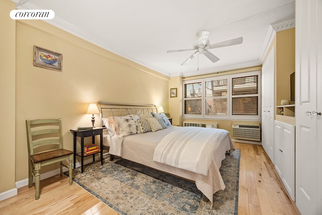 bedroom with light wood finished floors, a wall mounted AC, visible vents, and crown molding