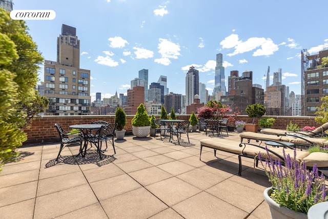 view of patio / terrace featuring a city view and outdoor dining space