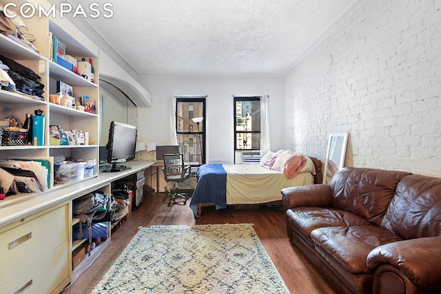 bedroom featuring a textured ceiling and dark hardwood / wood-style floors