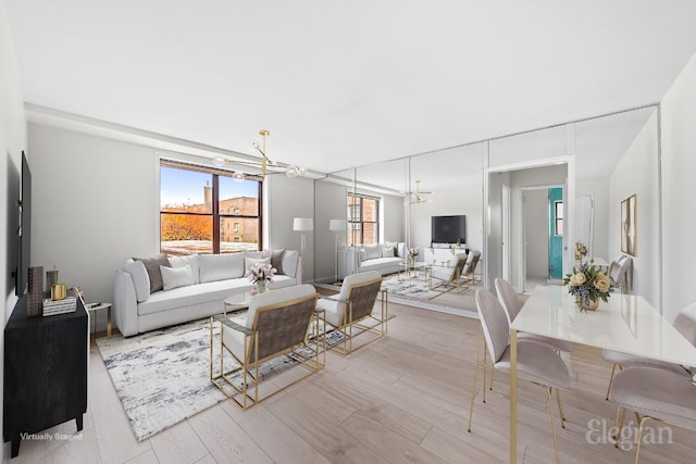 living room with a wealth of natural light and a notable chandelier